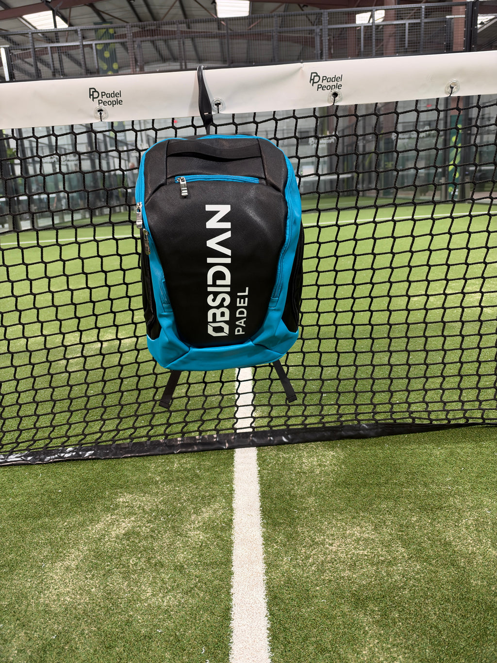Obsidian Padel Backpack in black and blue alongside the black Obsidian Tournament Padel Bag