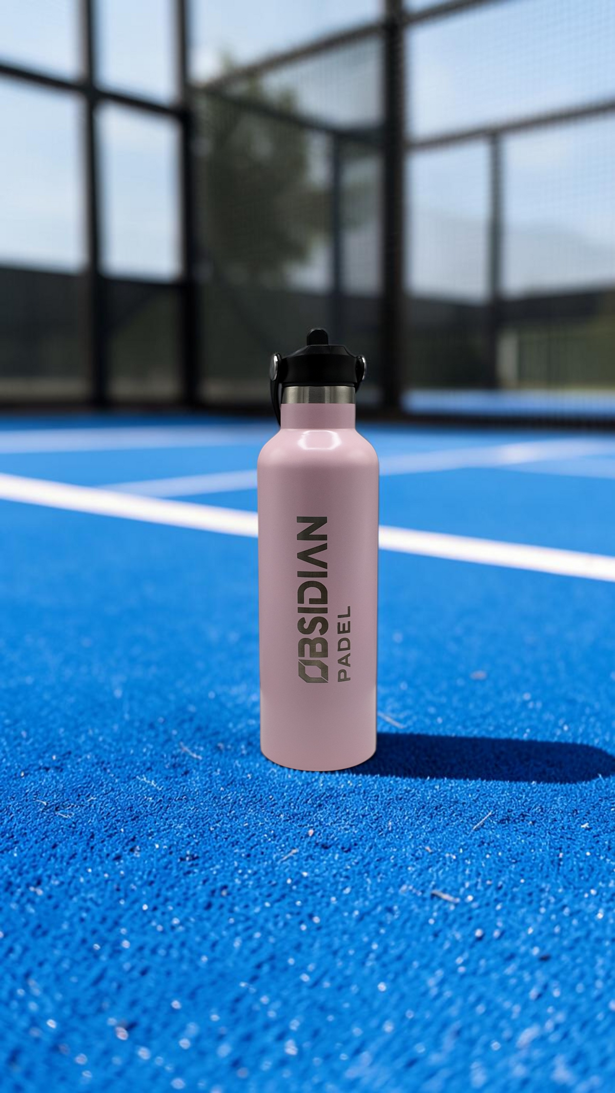 Obsidian Padel pink insulated aluminium water bottle with integrated cage clip and logo on a white display stand.